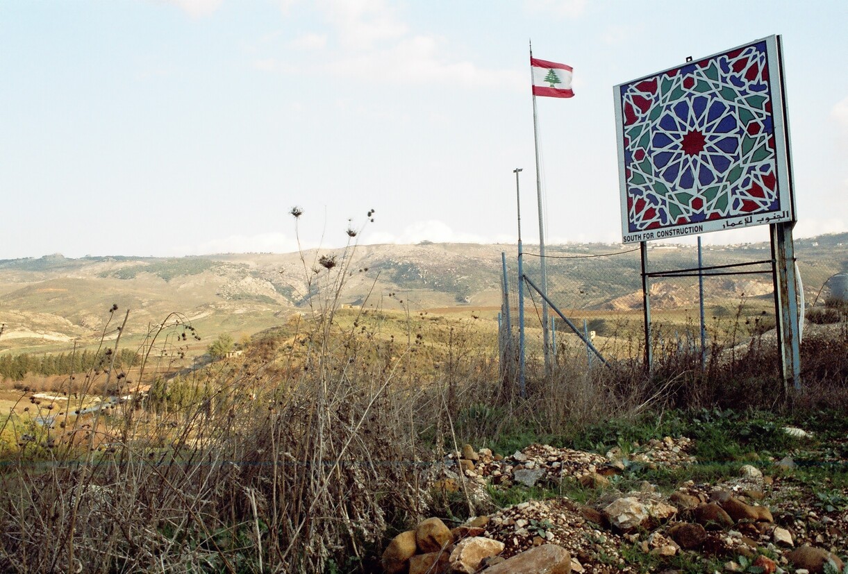 A placard and a flag in a rural landscape
