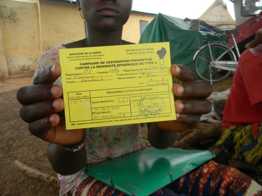 Person holding up Meningitis Type A Vaccination card