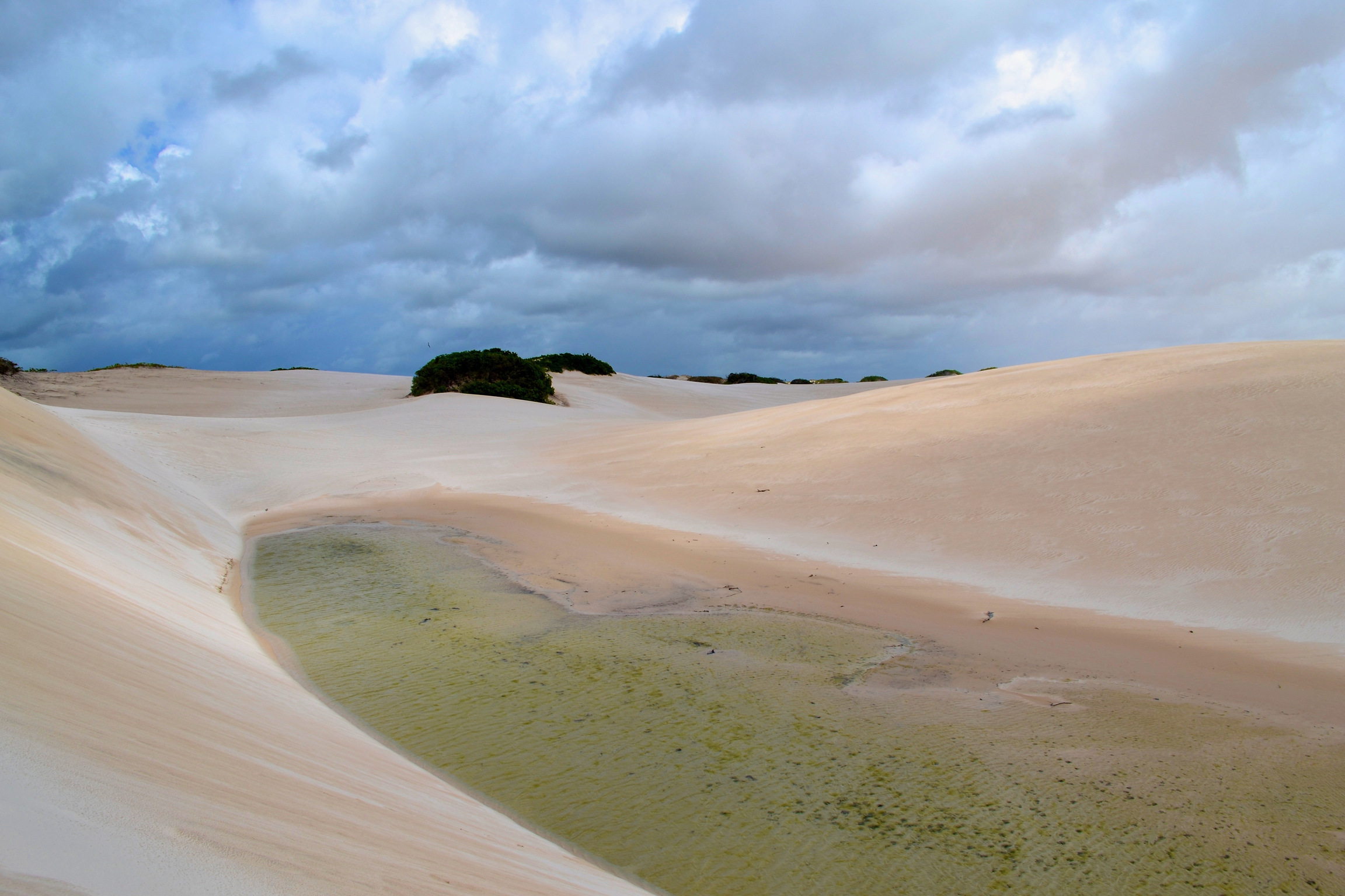 Lençóis Maranhenses National Park, Brazil. Clouds hover over a rain-filled lagoon that appears like a mirage