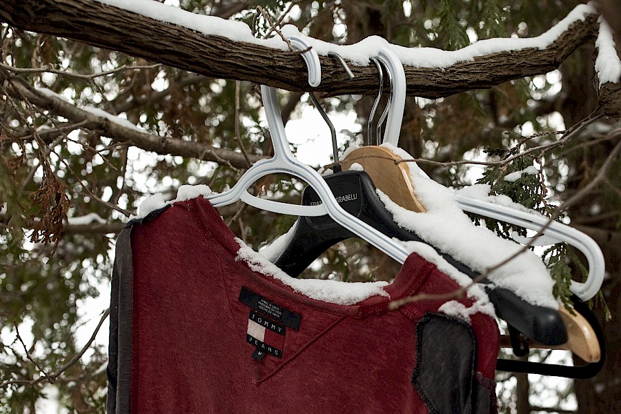 9. Clothing hung on tree branches behind baseball stadium, adjacent to riverfront bike path, February 2014
