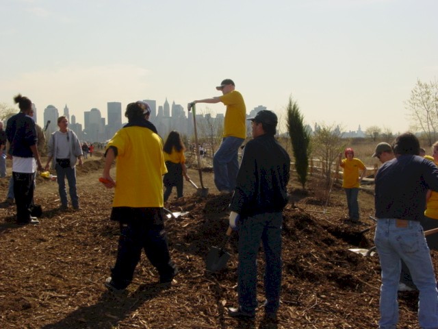 1. The New York City skyline provides the backdrop as stewards plant hundreds of trees and perennials in the Grove of Remembrance. Jersey City, New Jersey.