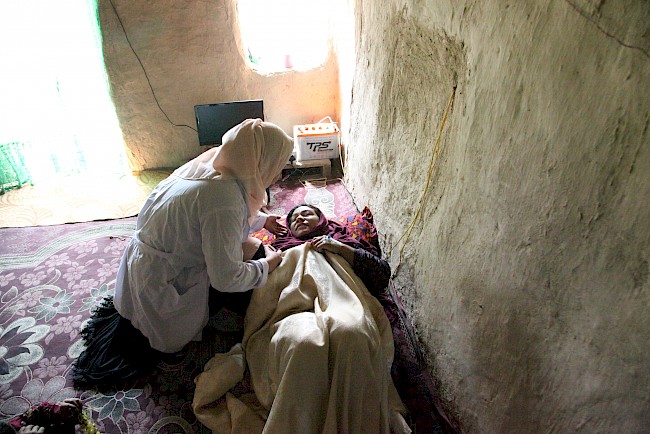 5. A Tabish midwife examines an Afghan mother. Tabish midwives trained traditional birth attendants to provide information, assessment, and contraceptive supplies to the participating women in the IDP camps. Sharak Mohamedia, Afghanistan, 2018.