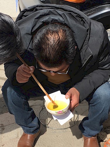 A Tibetan doctor examines a urine sample