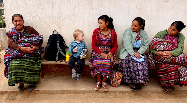 5. My son sits with a group of Mam-speaking women in highland Guatemala. Photo by the author.