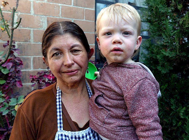6. Consuela Guerra Xícara holds my son at her house in the state of Quetzaltenango, Guatemala. Photo by the author.